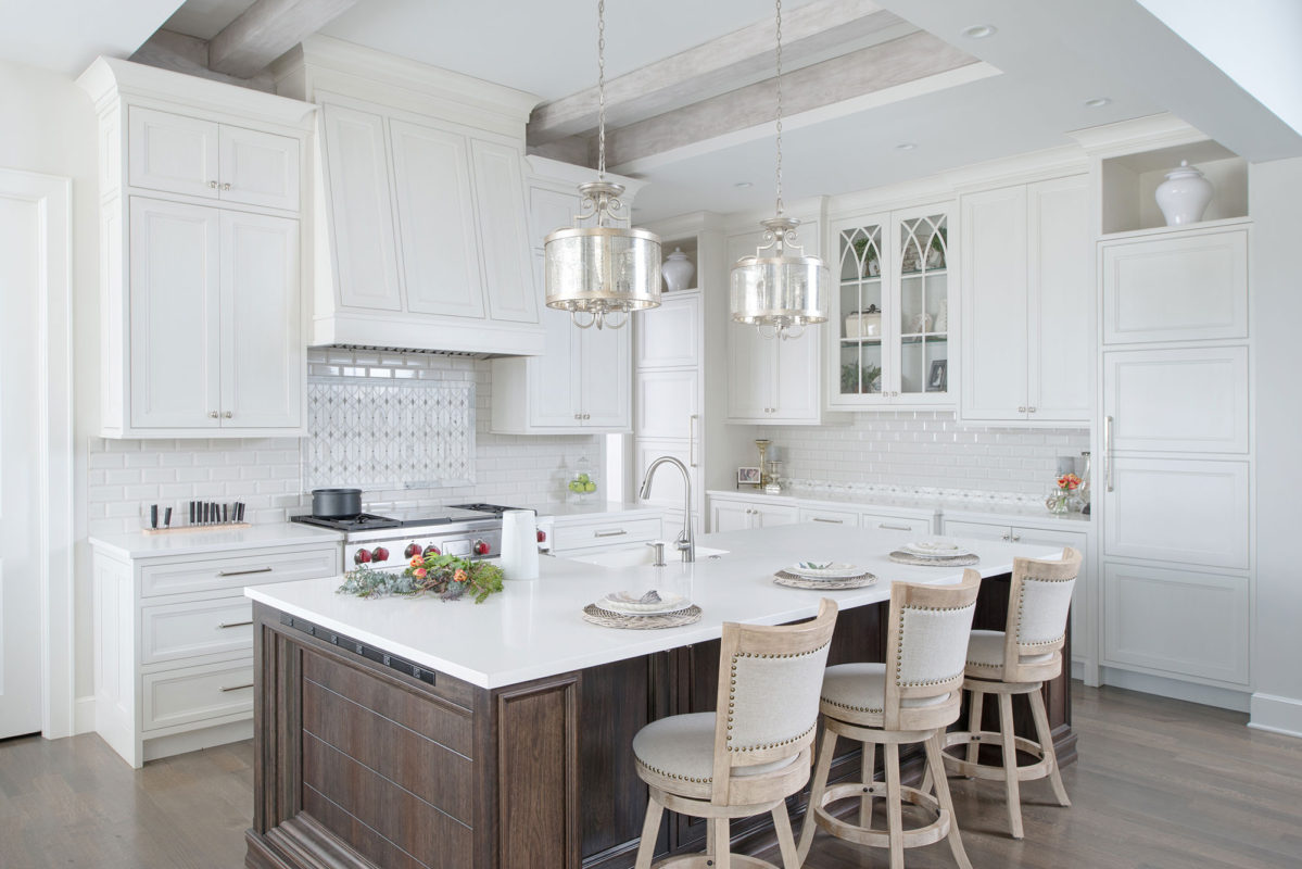 White Kitchen Cabinets with large range hood by Crystal Cabinet Works