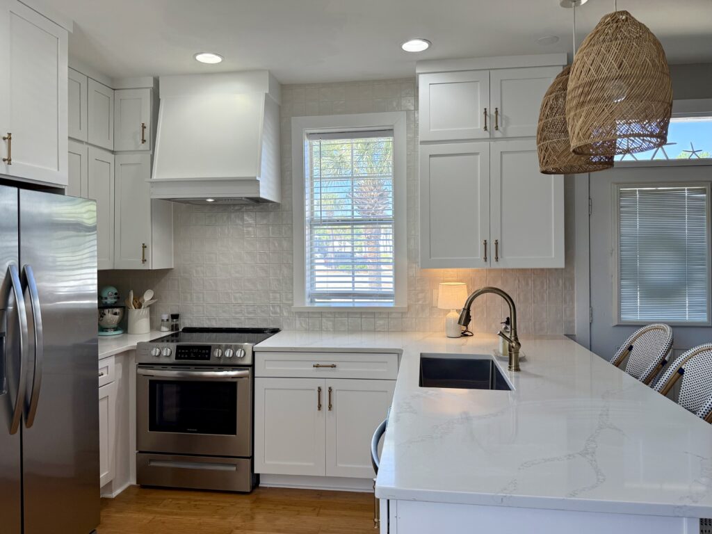 Wellborn Saybrook bright white kitchen featuring lower cabinets on the peninsula featuring quartz countertop Milano