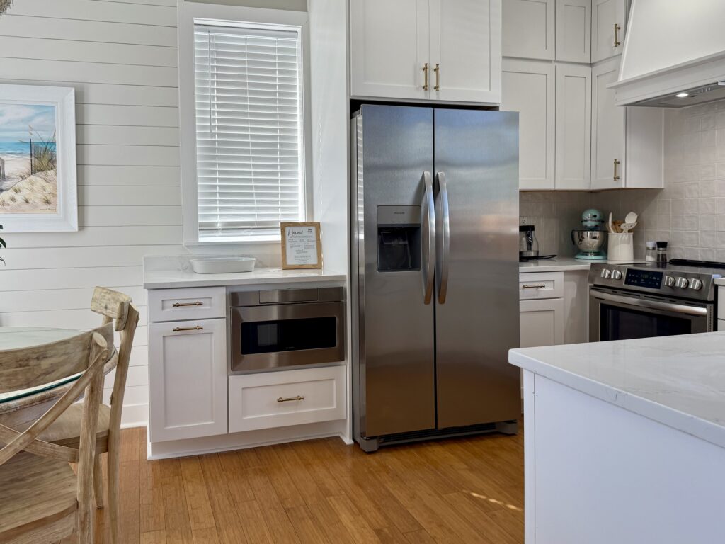 Wellborn Saybrook bright white kitchen cabinets featuring a refrigerator and microwave cabinet