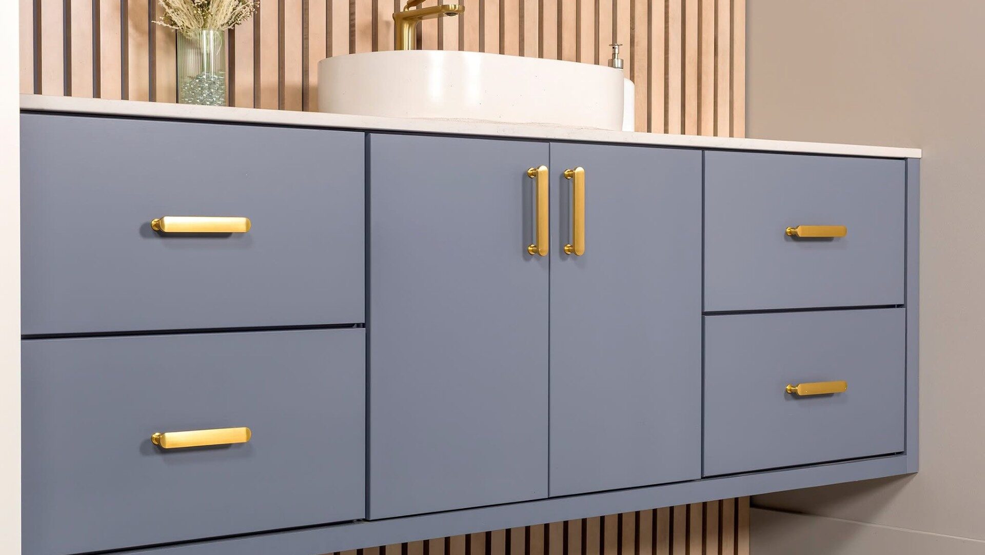 wall-mounted vanity in dusty blue with bronze colored hardware