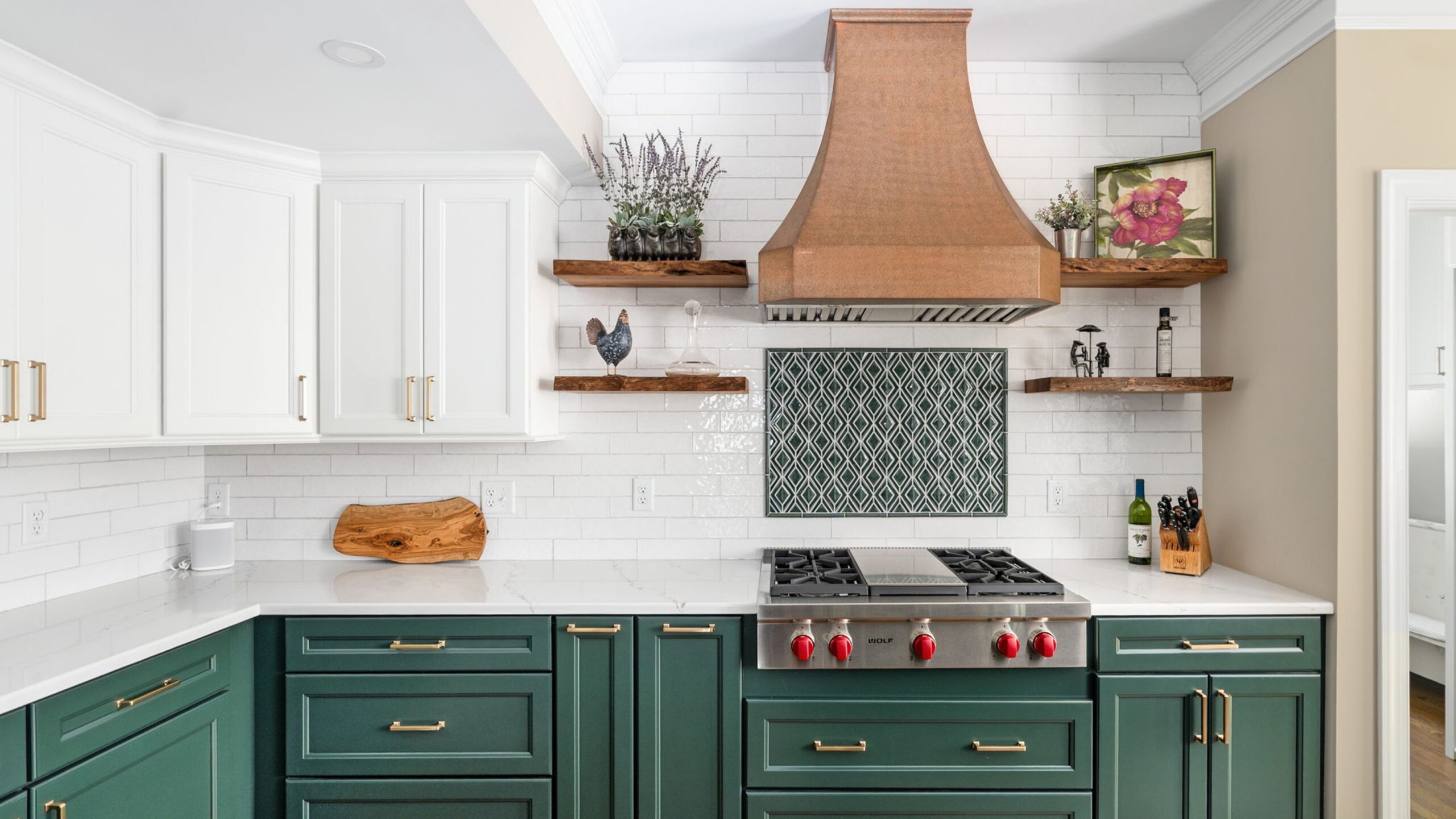 Wellborn featured Kitchen with green lower base cabinets, white upper cabinets and shelving around the cooktop